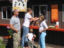 Family about to enjoy some apple cider at Pumpkinville