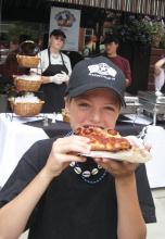 Girl tasting pizza at a Taste of Ellicottville